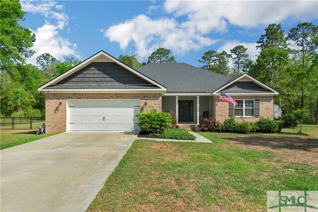 107 Mingledorff Way, Springfield, GA 31329 - view of front of property featuring a front lawn, fence, concrete driveway, and brick siding