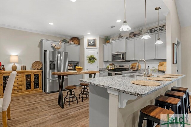 107 Mingledorff Way, Springfield, GA 31329 - kitchen featuring light stone counters, stainless steel appliances, a sink, a peninsula, and a kitchen breakfast bar