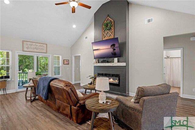 107 Mingledorff Way, Springfield, GA 31329 - living area featuring ceiling fan, a large fireplace, baseboards, wood finished floors, and high vaulted ceiling