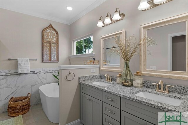 107 Mingledorff Way, Springfield, GA 31329 - bathroom with tile walls, a sink, a freestanding bath, and double vanity