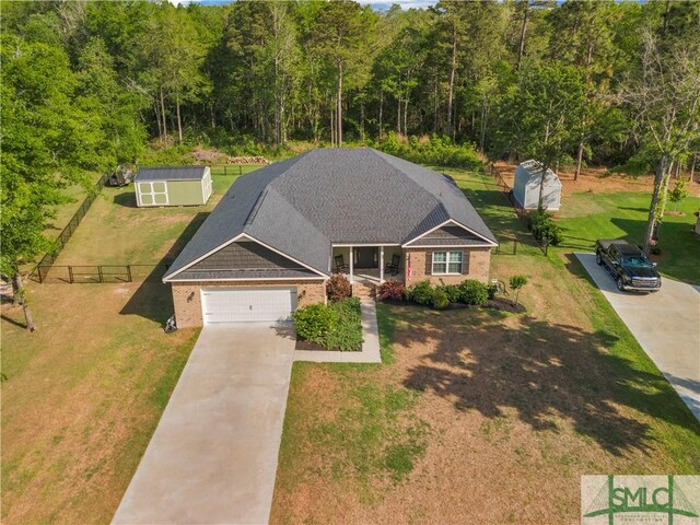 107 Mingledorff Way, Springfield, GA 31329 - view of front of home with a front lawn, driveway, a garage, and fence