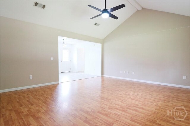 309 Wilkinson Rd NE, Ludowici, GA 31316 - empty room featuring light wood-type flooring, beam ceiling, high vaulted ceiling, a ceiling fan, and baseboards