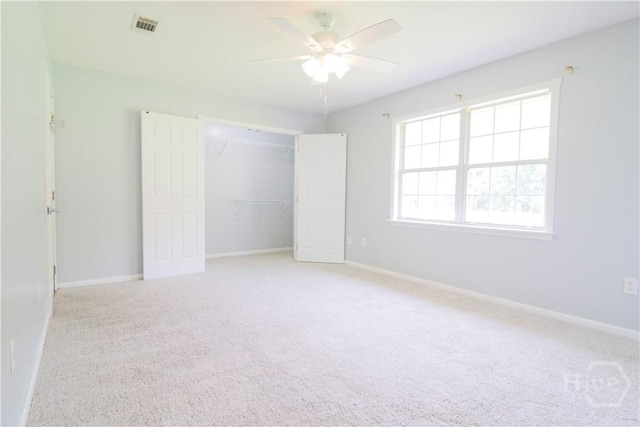 309 Wilkinson Rd NE, Ludowici, GA 31316 - unfurnished bedroom with light colored carpet, baseboards, a closet, and ceiling fan