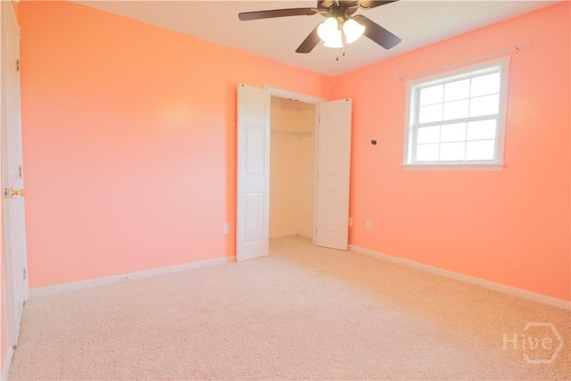 309 Wilkinson Rd NE, Ludowici, GA 31316 - unfurnished bedroom featuring light carpet, baseboards, and ceiling fan