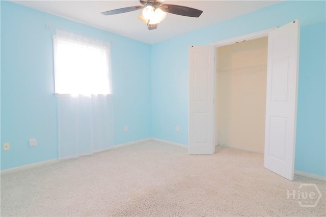 309 Wilkinson Rd NE, Ludowici, GA 31316 - unfurnished bedroom with light carpet, baseboards, and ceiling fan
