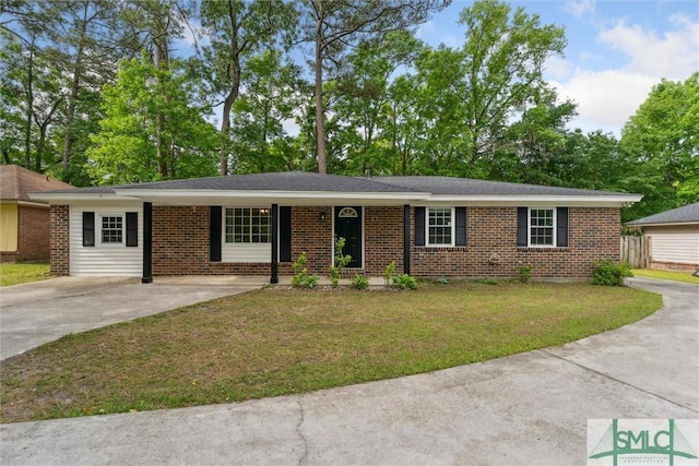 ranch-style home with driveway, a front yard, and brick siding
