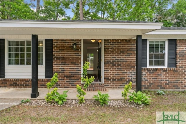 property entrance with brick siding