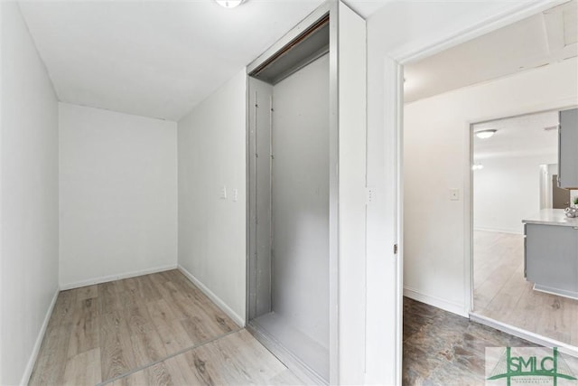 interior space featuring wood finished floors and baseboards
