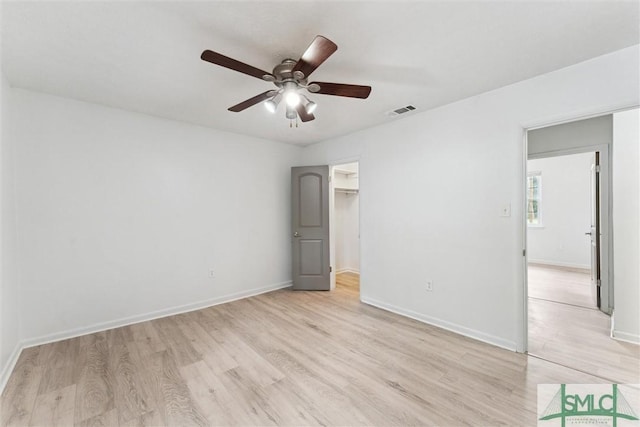 unfurnished bedroom featuring baseboards, visible vents, and light wood-style flooring