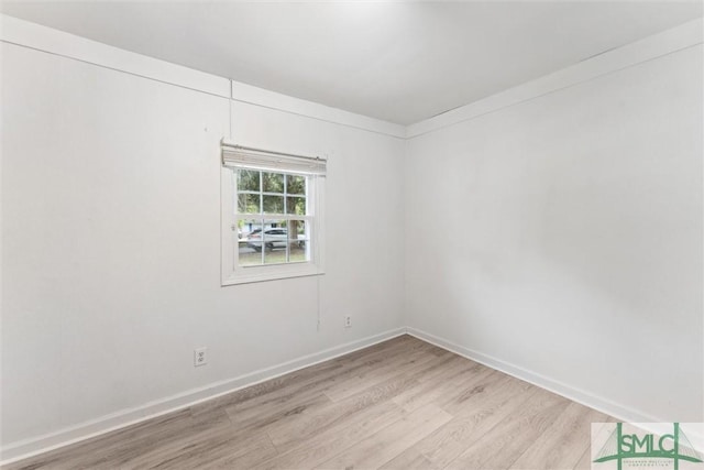 empty room with light wood-style flooring and baseboards