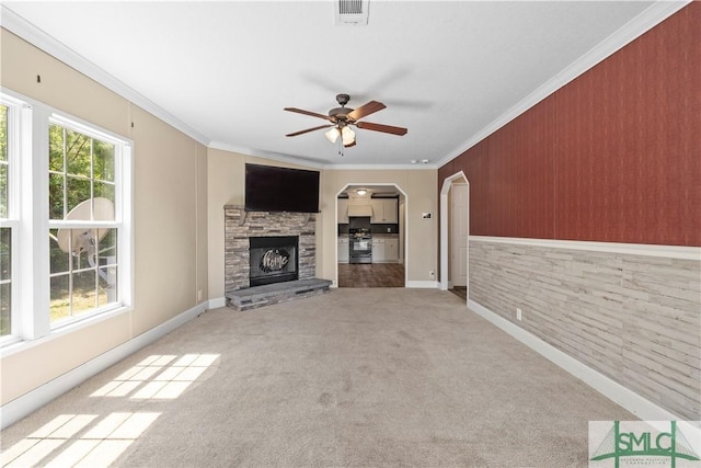 1173 Ga Highway 21 N, Springfield, GA 31329 - unfurnished living room featuring crown molding, visible vents, ceiling fan, carpet floors, and a stone fireplace