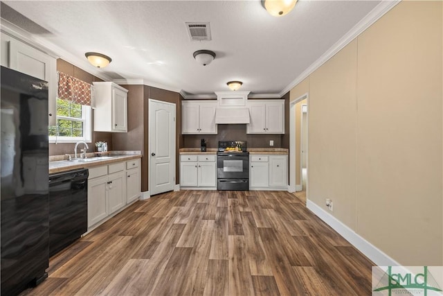 1173 Ga Highway 21 N, Springfield, GA 31329 - kitchen featuring white cabinetry, crown molding, a sink, black appliances, and dark wood finished floors
