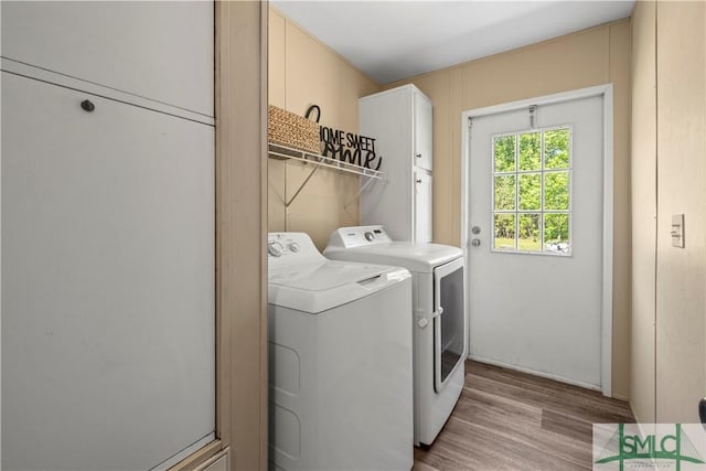 1173 Ga Highway 21 N, Springfield, GA 31329 - laundry room with light wood-style flooring, washing machine and clothes dryer, and cabinet space