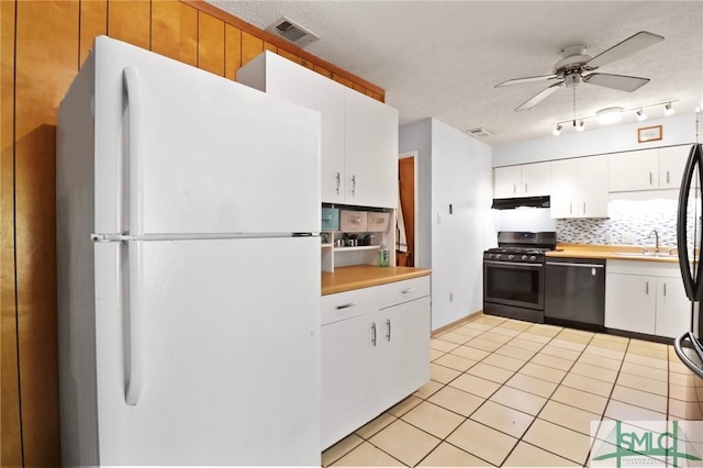 kitchen featuring stainless steel appliances, a ceiling fan, backsplash, light tile patterned floors, and under cabinet range hood