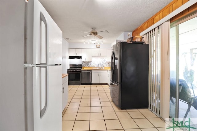 kitchen with ceiling fan, light countertops, white cabinetry, appliances with stainless steel finishes, and backsplash