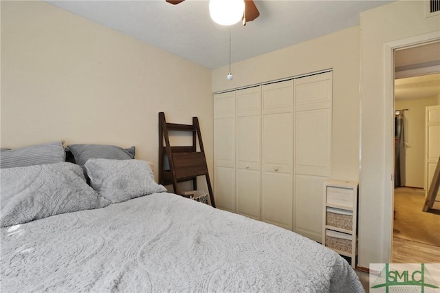 bedroom with a closet, ceiling fan, and light wood-type flooring