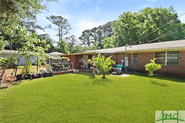 rear view of property featuring a lawn