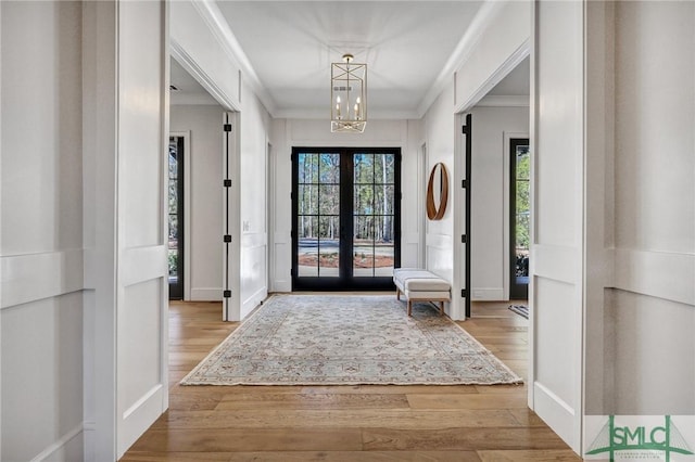 31 Tivoli Ln, Richmond Hill, GA 31324 - entryway featuring baseboards, wood finished floors, an inviting chandelier, and crown molding