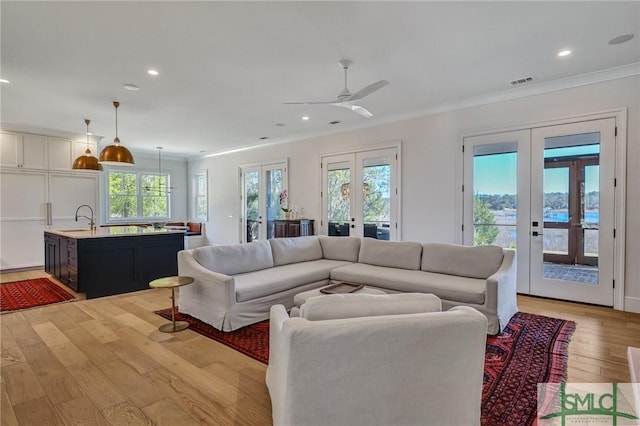 31 Tivoli Ln, Richmond Hill, GA 31324 - living area featuring recessed lighting, light wood-style flooring, a ceiling fan, french doors, and crown molding