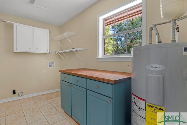 53 Kevin Rd, Hinesville, GA 31313 - clothes washing area featuring cabinet space, light tile patterned flooring, washer hookup, baseboards, and electric water heater
