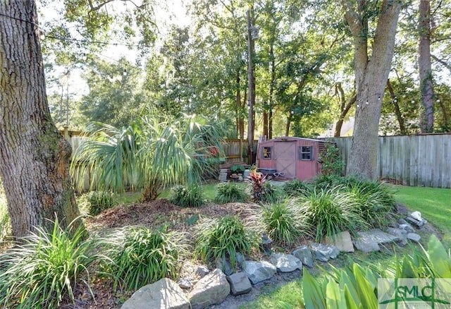 8 Baker Dr, Savannah, GA 31410 - view of yard with a storage unit, a fenced backyard, and an outbuilding