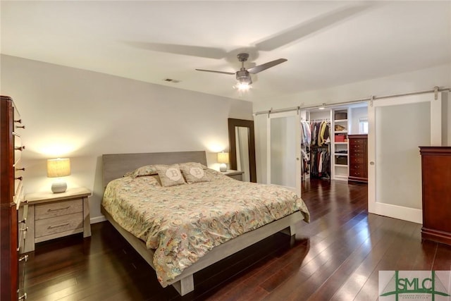 8 Baker Dr, Savannah, GA 31410 - bedroom featuring a walk in closet, dark wood-type flooring, a barn door, and visible vents