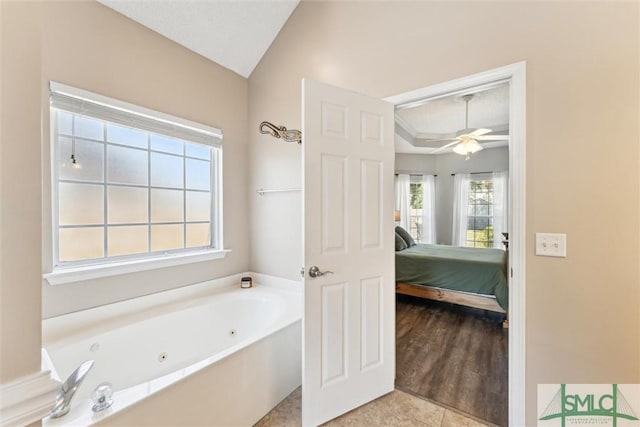 bathroom featuring tile patterned flooring, a ceiling fan, ensuite bath, and a jetted tub