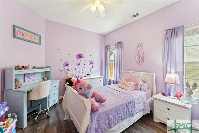 bedroom with wood finished floors, visible vents, and a ceiling fan