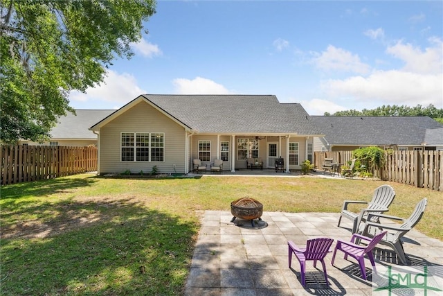 125 Blue Lake St, Richmond Hill, GA 31324 - rear view of house featuring an outdoor fire pit, a patio area, a fenced backyard, and a lawn