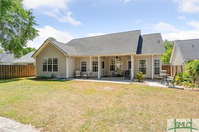 125 Blue Lake St, Richmond Hill, GA 31324 - back of property with a yard, roof with shingles, a patio area, and a fenced backyard