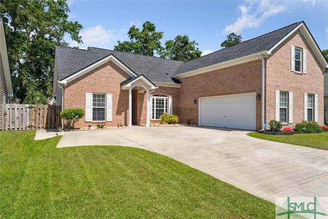 view of front of home with a gate, concrete driveway, a front yard, and brick siding