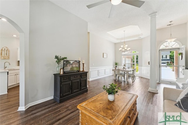 125 Blue Lake St, Richmond Hill, GA 31324 - living room with a ceiling fan, a wainscoted wall, a decorative wall, arched walkways, and dark wood-style floors