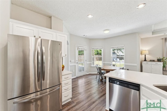 125 Blue Lake St, Richmond Hill, GA 31324 - kitchen featuring white cabinetry, stainless steel appliances, a textured ceiling, and dark wood-style floors