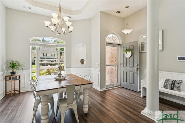 interior space with a chandelier, visible vents, a high ceiling, and dark wood-style flooring