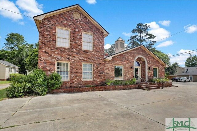 traditional-style home with brick siding