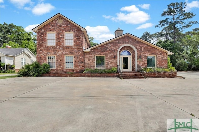 traditional-style house featuring brick siding