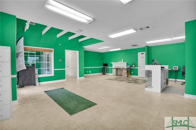 miscellaneous room featuring tile patterned flooring, visible vents, and baseboards