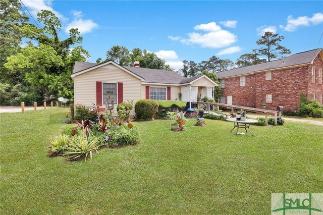 rear view of property with a yard and brick siding