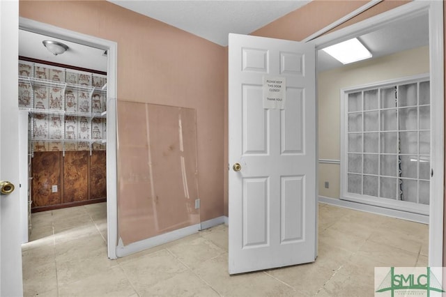 bathroom featuring tile patterned flooring and baseboards