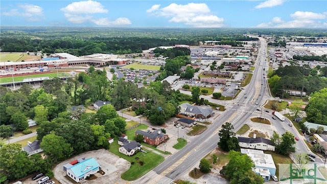 drone / aerial view with a wooded view