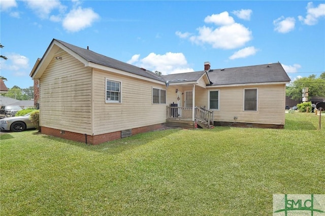 rear view of house with a yard and crawl space