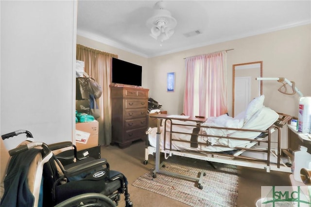 carpeted bedroom featuring visible vents and ornamental molding