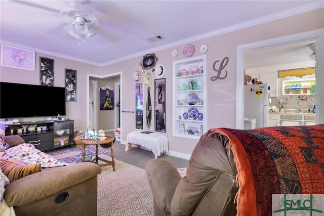 living room featuring crown molding, carpet flooring, visible vents, baseboards, and a ceiling fan
