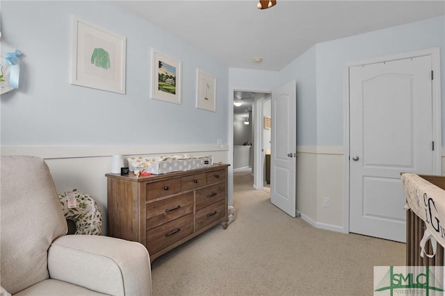sitting room featuring light colored carpet