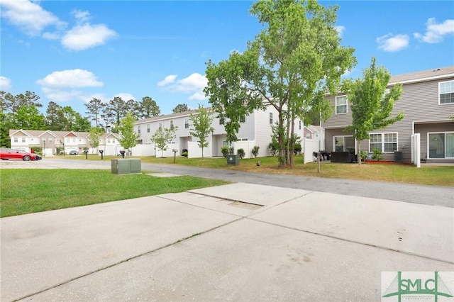 exterior space featuring a residential view and a yard