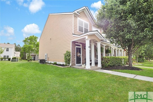 view of front facade featuring brick siding, a front lawn, central AC unit, and a porch
