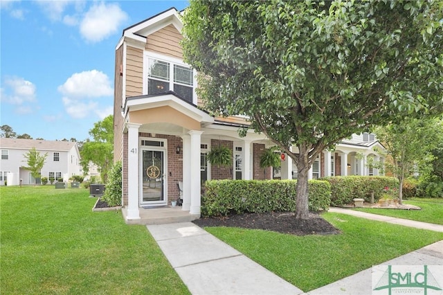 view of front of house featuring a front lawn, central AC, and brick siding