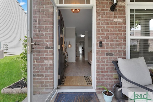doorway to property with brick siding