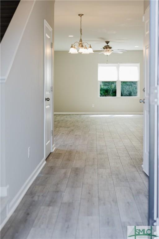 154 Hamilton Grove Dr, Pooler, GA 31322 - interior space with baseboards, light wood finished floors, and ceiling fan with notable chandelier