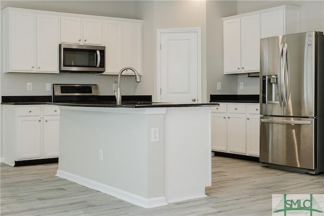154 Hamilton Grove Dr, Pooler, GA 31322 - kitchen with light wood-style floors, appliances with stainless steel finishes, white cabinets, and dark countertops
